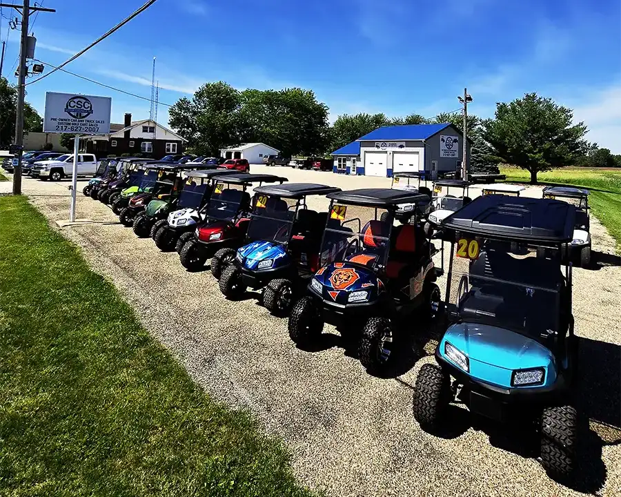 Full lineup of custom-built golf carts parked at the CSC Motor Company sales lot near Litchfield, IL