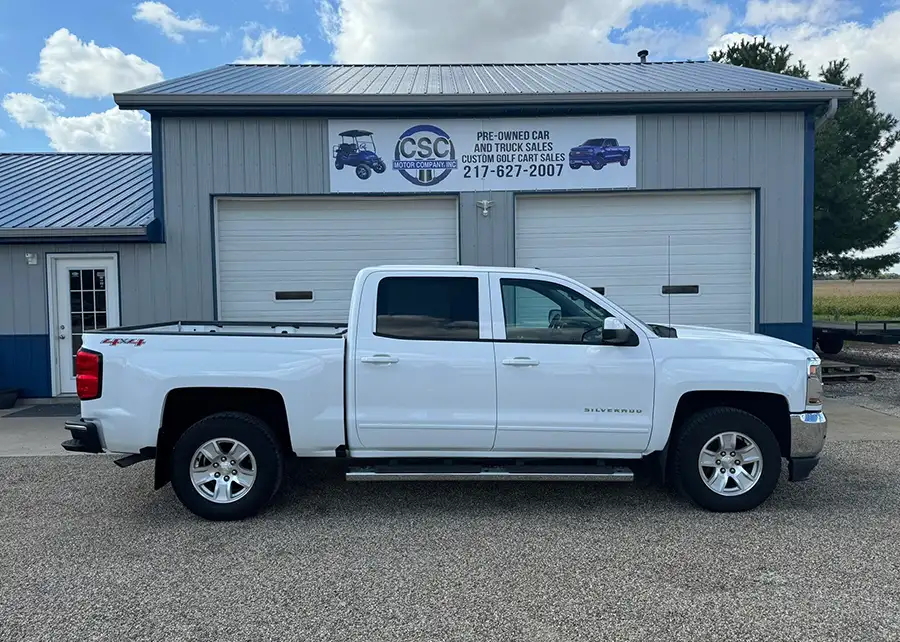 White Chevrolet Silverado pickup truck parked outside CSC Motor Company dealership building near Springfield, IL