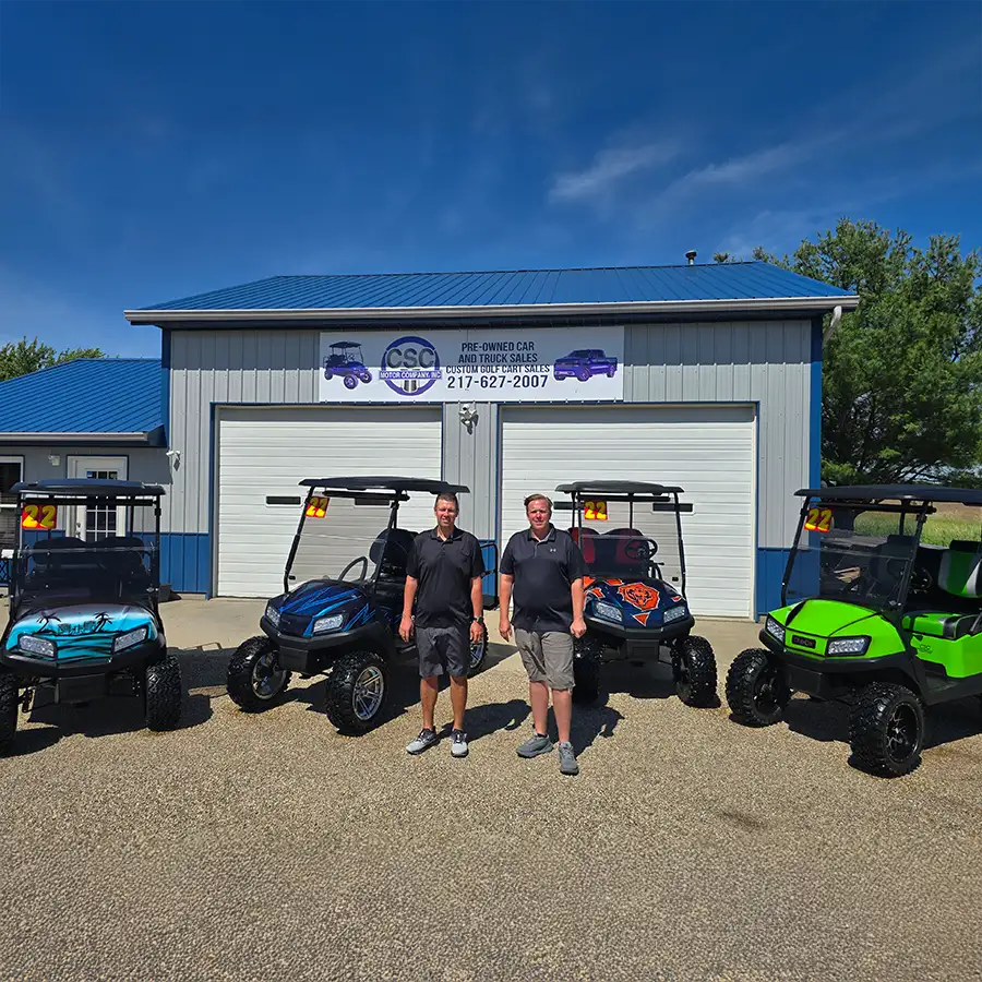 CSC Motor Company staff posing with a row of custom golf carts outside the shop near Springfield, IL