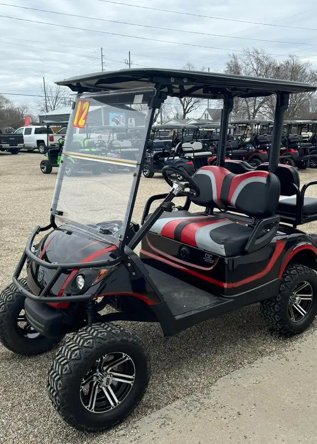Black and red custom golf cart with chrome wheels parked in the CSC Motor Company lot, Springfield, IL