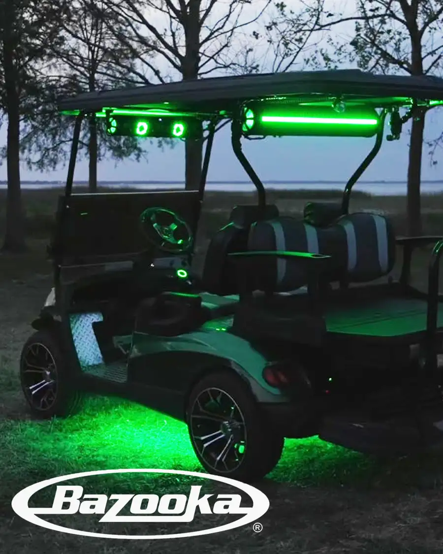 Customized golf cart with green LED underglow and Bazooka speakers lit up at night – CSC Motor Company Springfield, IL
