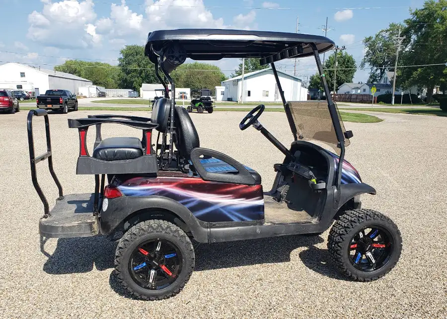 Customized golf cart with red, white, and blue lightning bolt wrap and red-accented wheels – CSC Motor Company Springfield, IL