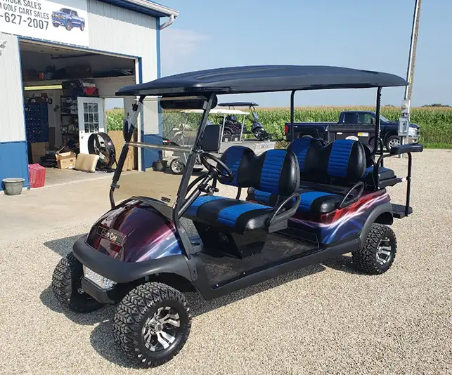 Six-seater customized golf cart with blue and black seats and purple lightning graphic wrap – CSC Motor Company Springfield, IL