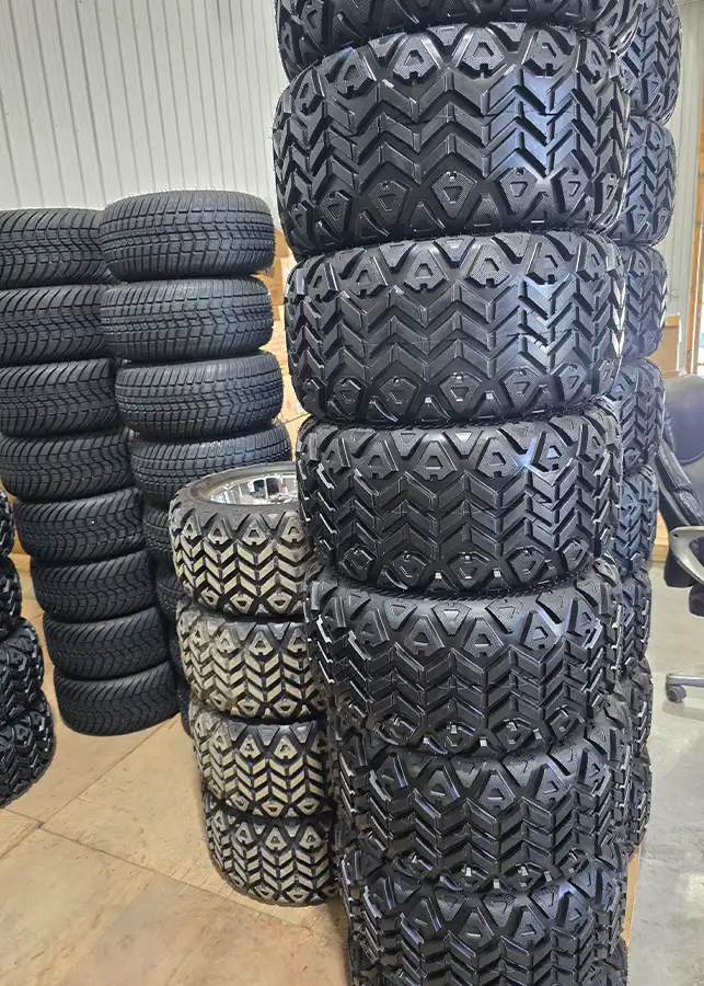 Stacks of golf cart tires and wheels in storage at CSC Motor Company Springfield, IL