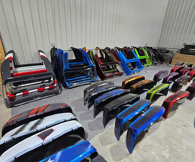 Rows of custom-painted golf cart body panels and hoods for custom built golf carts - CSC Motor Company Springfield, IL