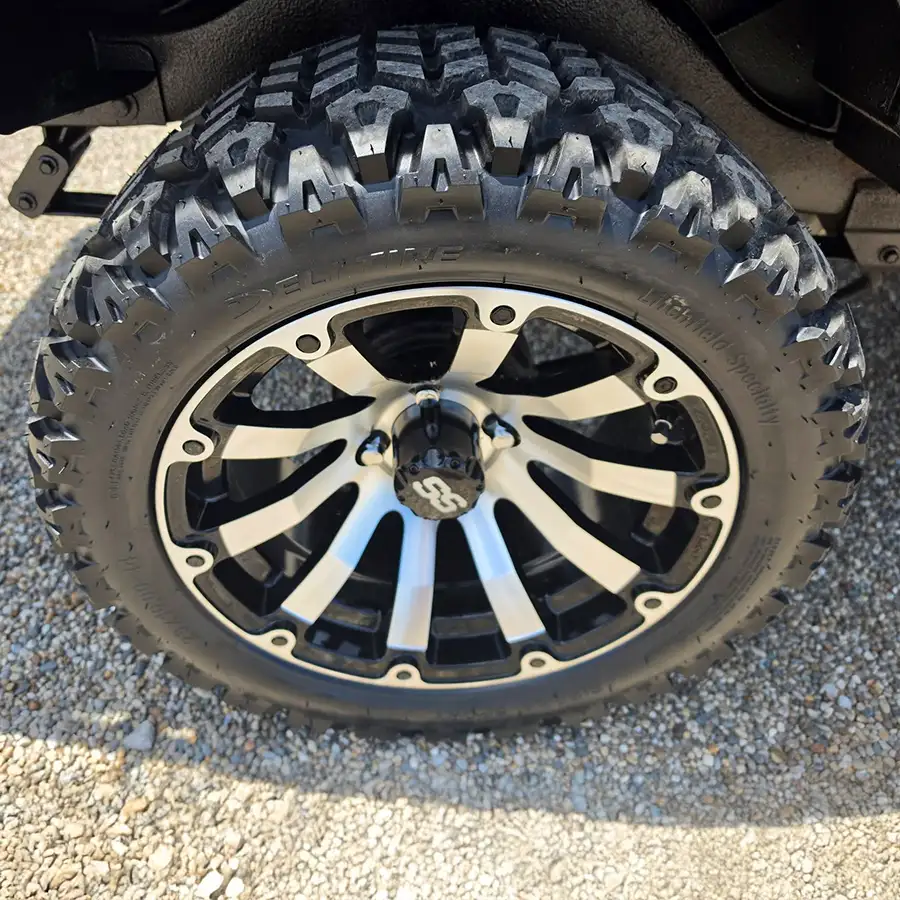 Close-up of black and machined aluminum golf cart wheel with all-terrain tire – CSC Motor Company Springfield, IL