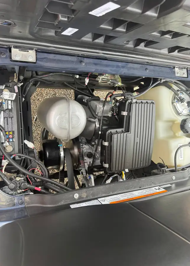 Close-up of golf cart engine and fuel tank components under open rear panel – CSC Motor Company Springfield, IL