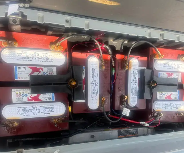 Trojan batteries wired together in golf cart battery compartment – CSC Motor Company Springfield, IL