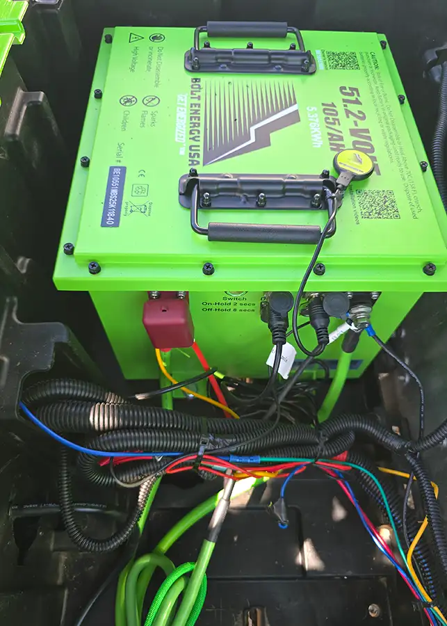 Close-up of green Bolt Energy USA lithium battery installed in golf cart – CSC Motor Company Springfield, IL