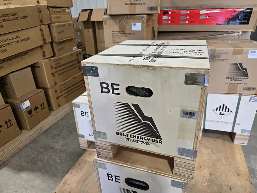 Crated Bolt Energy USA lithium battery kits stacked in CSC Motor Company's Springfield, IL shop
