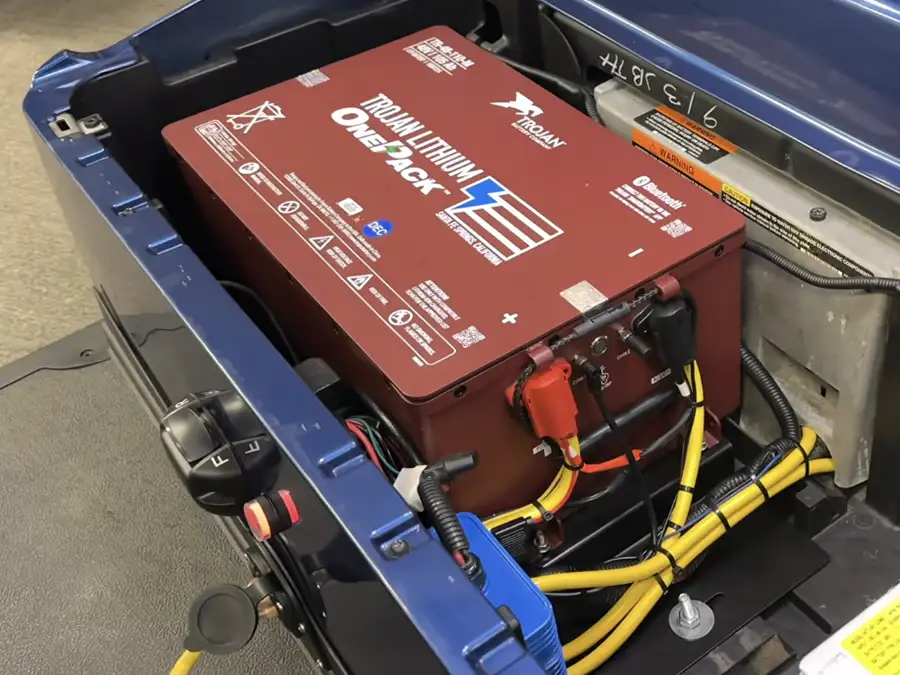 Trojan Lithium OnePack battery installed in blue golf cart battery compartment – CSC Motor Company Springfield, IL